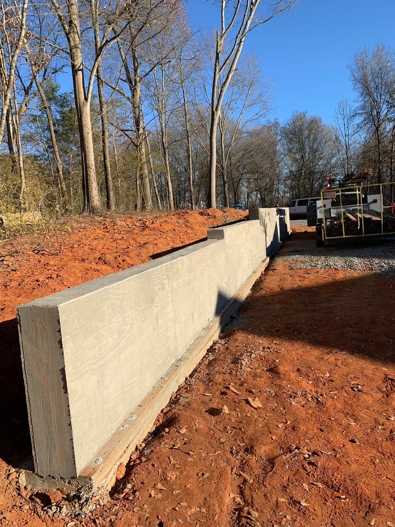 Concrete retaining wall project with prepared base and forms
